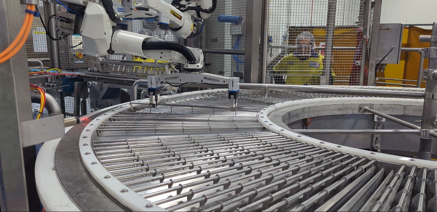 Cobot tending a spiral conveyor