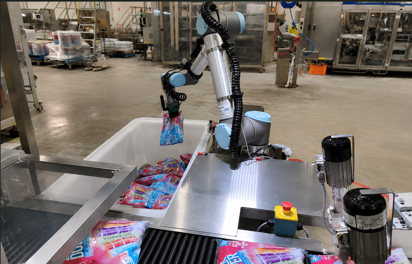 Cobot picking ice-block packs from a bin onto a conveyor